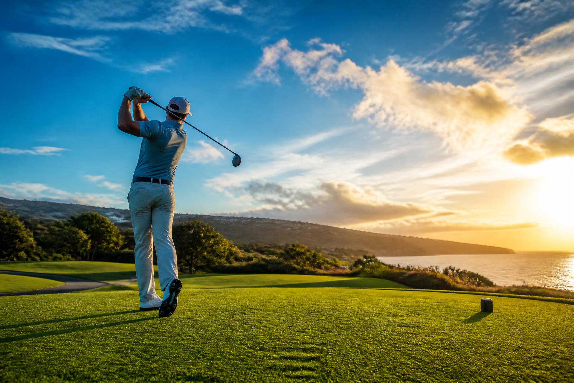 Golfer at sunrise on a coastal fairway